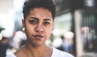 Face of young woman with white earrings