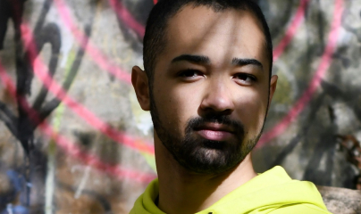 Face of young man in yellow hoodie